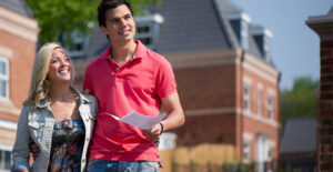 Couple smiling and exploring a college campus