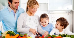 a family cooks a healthy meal to prevent the onset of diabetes