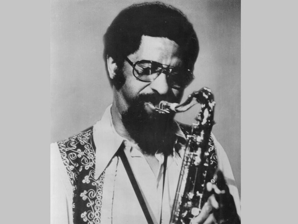 Sonny Rollins performing on the saxophone in a photo from 1974.