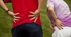 a couple holds their hips in pain