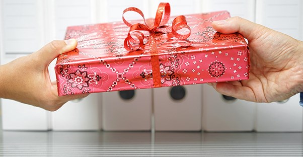 Two people exchanging a gift