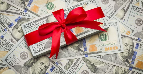 Stack of money with a red ribbon around it
