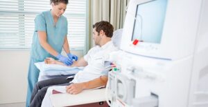 A nephrologist works with a patient