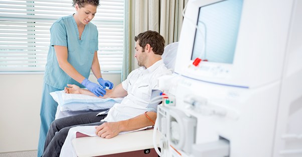 A nephrologist works with a patient