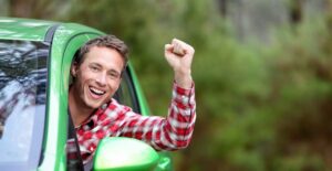 Young man excited to drive his first car
