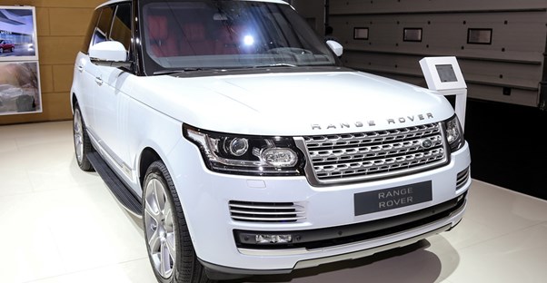 A luxury land rover sitting in a show room