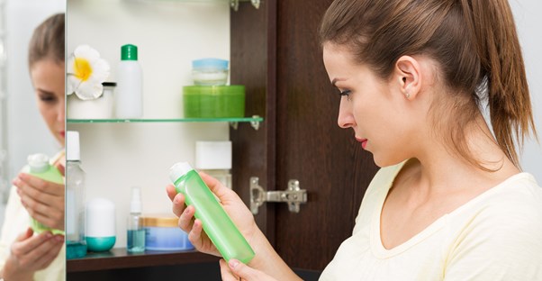 A woman deliberates about skin care products