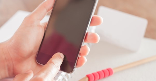 Hands using a phone at a mobile store