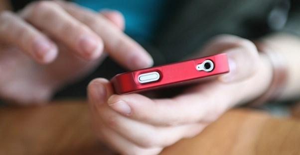 Woman using her iphone while it is in a protective case