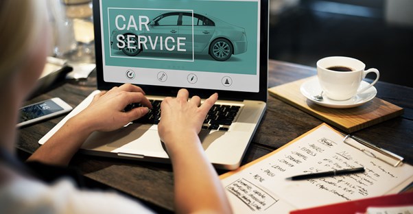 Woman looking for car service on her laptop
