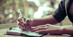 Person writing in journal
