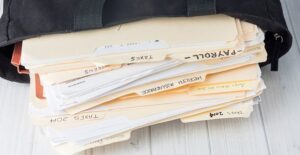 Stack of folders that represent how confusing bookkeeping fees can be