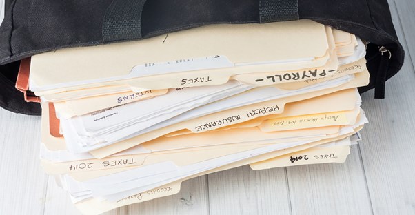 Stack of folders that represent how confusing bookkeeping fees can be