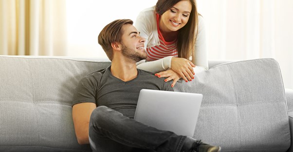 A couple who run their own business looking online to file taxes