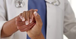 A doctor consoles a patient with acromegaly
