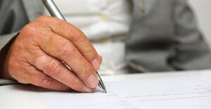 Man's hand writing letter
