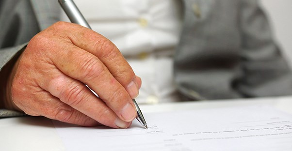 Man's hand writing letter