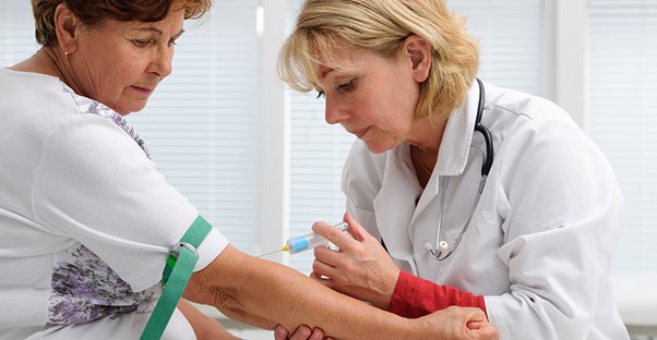 A doctor draws blood