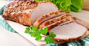 Sliced pork roast on a cutting board
