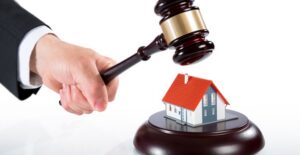 Gavel about to crush a tiny house