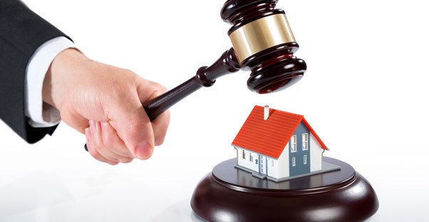 Gavel about to crush a tiny house