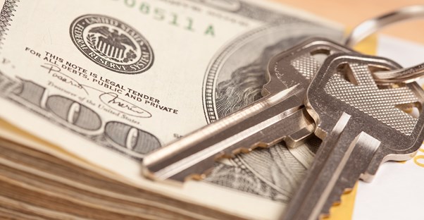 Keys on top of a stack of quick cash from a short sale