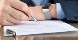 Man in a suit writing a letter