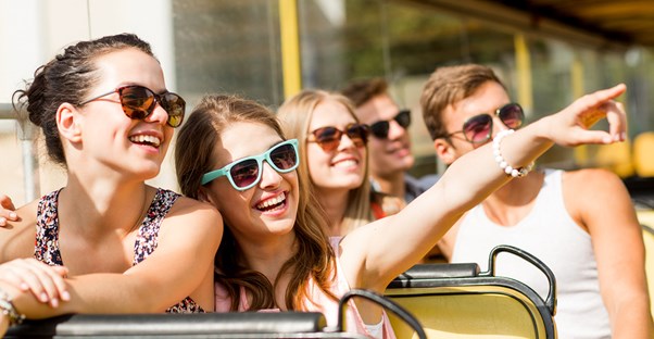 A family enjoys their 24 hour getaway aboard a sightseeing bus.