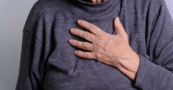 An elderly woman wheezes