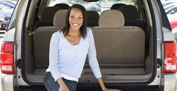Woman shopping for a new minivan