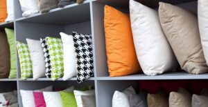 Shelves of a store holding pillows a newly engaged couple would like