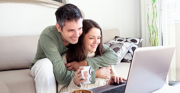 Affectionate engaged couple registering for wedding gifts
