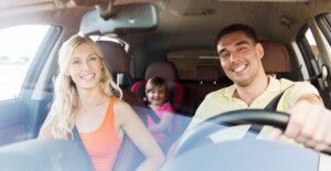 Family sitting in a new car