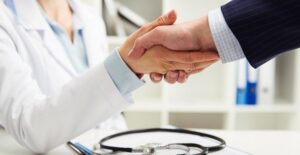 A doctor and RAD parent shake hands