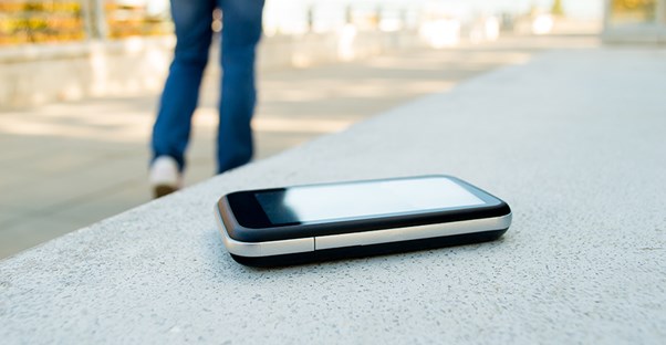 Person walking away from a cell phone left behind