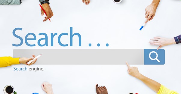 Several people with markers about to write in a printed Search box