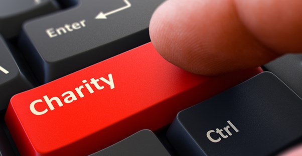 Finger on red keyboard key that says "Charity"