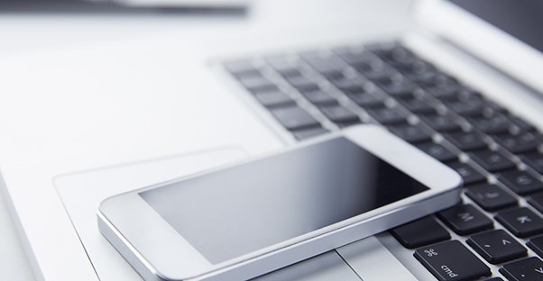 cell phone on top of laptop