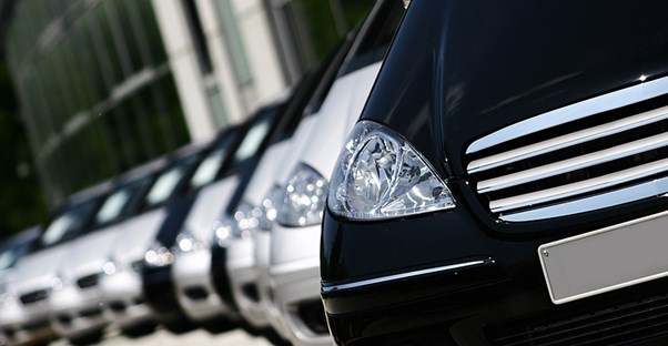 Line of new cars at a dealership covered by manufacturer warranty