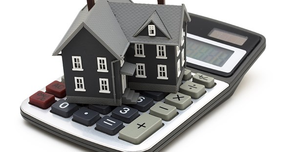 tiny house on top of a calculator
