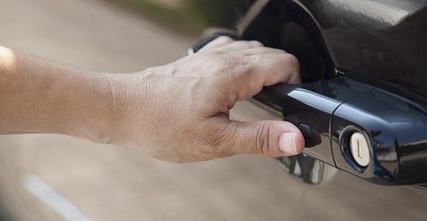 hand opening car door to new car