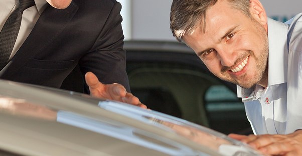 two guys giving a car an appraisal