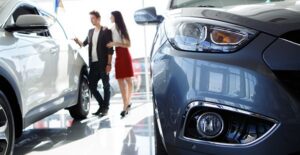 man and woman looking at trading in car