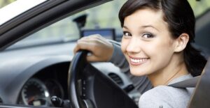 girl smiling in car after trading in