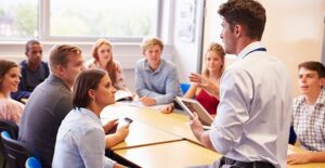 teacher talking to students in classroom at community college