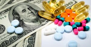 Money with pills scattered on top