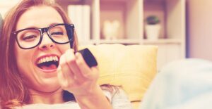 girl watching tv and laughing