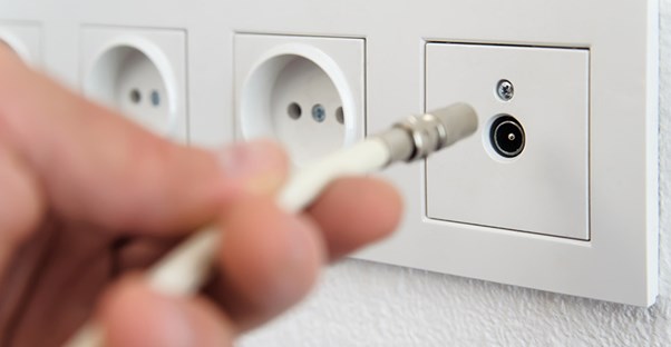 plugging coaxial cable into wall