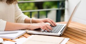 Freelance writer typing away on a laptop