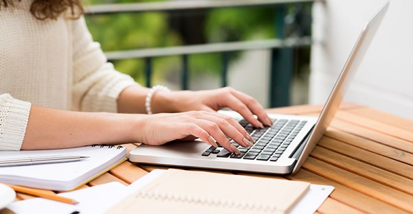 Freelance writer typing away on a laptop